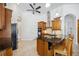 A large kitchen island features granite counters and a stainless vent hood over the cooking area at 748 Mills Estate Pl, Chuluota, FL 32766
