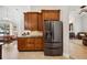 Kitchen area featuring stainless steel appliances, wood cabinets, tile backsplash, and stone floors at 748 Mills Estate Pl, Chuluota, FL 32766