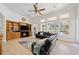 Spacious living room has a ceiling fan and a fireplace with built in shelving at 748 Mills Estate Pl, Chuluota, FL 32766