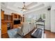 Spacious living room with built-in shelves, a treadmill, and shuttered windows at 748 Mills Estate Pl, Chuluota, FL 32766