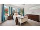 Bright main bedroom with bay windows overlooks the screened pool area and has stylish furnishings at 748 Mills Estate Pl, Chuluota, FL 32766