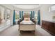 Bright main bedroom with bay windows overlooks the screened pool area and has stylish furnishings at 748 Mills Estate Pl, Chuluota, FL 32766