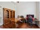 Spacious office with wood floors, built-in shelves, and an executive desk setup at 748 Mills Estate Pl, Chuluota, FL 32766