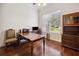 Office featuring wood floors, a large window, and a traditional desk setup at 748 Mills Estate Pl, Chuluota, FL 32766