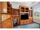 Home office features custom wood built-ins, desk space, and a large window for natural light at 748 Mills Estate Pl, Chuluota, FL 32766