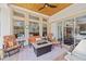 Cozy covered patio with ample seating, a fire pit, and views of the backyard and swimming pool at 748 Mills Estate Pl, Chuluota, FL 32766