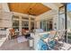 Well-equipped outdoor kitchen and patio area with a grill, bar seating, and comfortable lounging options at 748 Mills Estate Pl, Chuluota, FL 32766