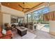 Inviting outdoor patio featuring a built-in grill, comfortable seating, a ceiling fan, and access to the pool at 748 Mills Estate Pl, Chuluota, FL 32766