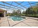 Captivating in-ground pool with screen enclosure featuring a jacuzzi and large patio for entertaining at 748 Mills Estate Pl, Chuluota, FL 32766