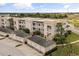 A condo building with lush green landscaping and private garages for each unit creating a welcoming community at 7509 Mourning Dove Cir # 204, Reunion, FL 34747