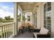 Covered balcony with ceiling fan featuring wooden table and seating perfect for enjoying outdoor meals and relaxing at 7509 Mourning Dove Cir # 204, Reunion, FL 34747