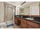 Bathroom featuring dual vanity, a walk-in shower with glass door, and tile floors at 7509 Mourning Dove Cir # 204, Reunion, FL 34747