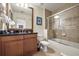 Bathroom featuring a vanity, a bath and shower combination with glass screen, and tile floors at 7509 Mourning Dove Cir # 204, Reunion, FL 34747