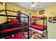 Bright bedroom with bunk beds, colorful decor, and a ceiling fan at 7509 Mourning Dove Cir # 204, Reunion, FL 34747