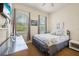 Bedroom with a full size bed, ample natural light, and light colored walls at 7509 Mourning Dove Cir # 204, Reunion, FL 34747