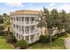 Three-story condo with multiple balconies, yellow and cream color scheme, and well-maintained landscaping at 7509 Mourning Dove Cir # 204, Reunion, FL 34747