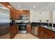 Modern kitchen featuring stainless steel appliances, dark countertops, ample cabinetry, and open layout at 7509 Mourning Dove Cir # 204, Reunion, FL 34747