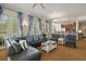 Spacious living room open to the kitchen featuring a comfortable leather sofa, stylish decor, and natural light at 7509 Mourning Dove Cir # 204, Reunion, FL 34747