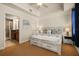 Bedroom with en-suite bathroom, neutral decor, a large bed, and modern lighting at 7509 Mourning Dove Cir # 204, Reunion, FL 34747