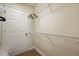 Bright walk-in closet offering shelving and an overhead rail at 7509 Mourning Dove Cir # 204, Reunion, FL 34747