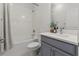 Bathroom with a shower over the tub, toilet and a grey vanity at 923 Colie Aly, Winter Garden, FL 34787