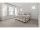Bright bedroom with neutral decor, plush carpeting, and ample natural light from large windows at 923 Colie Aly, Winter Garden, FL 34787