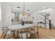 Open-concept dining area with modern lighting, adjacent to a stylish kitchen and staircase at 923 Colie Aly, Winter Garden, FL 34787