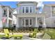 Inviting two-story home with rocking chairs on the porch and an outdoor seating area at 923 Colie Aly, Winter Garden, FL 34787