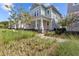 Charming two-story home with inviting front porch and beautifully landscaped yard and black metal fence at 923 Colie Aly, Winter Garden, FL 34787