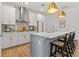 Modern kitchen with stainless steel appliances, island with seating, and ample cabinet space at 923 Colie Aly, Winter Garden, FL 34787