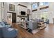 Beautifully decorated living room with a brick fireplace, wood floors, and comfortable seating arrangement at 923 Colie Aly, Winter Garden, FL 34787