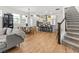 Bright and airy living space with a staircase and an open floor plan to kitchen and dining area at 923 Colie Aly, Winter Garden, FL 34787