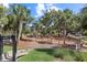Community playground with a slide, climbing structures, and mature trees creating a fun outdoor space at 923 Colie Aly, Winter Garden, FL 34787