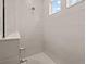 Bright shower with white tile, mosaic floor, and natural light from two windows at 923 Colie Aly, Winter Garden, FL 34787