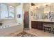 Bathroom features a soaking tub, glass-enclosed shower and dual sinks at 930 Willow Oak Loop, Minneola, FL 34715