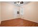 Bright bedroom features ceiling fan, wood floors, and a window with adjustable blinds at 930 Willow Oak Loop, Minneola, FL 34715