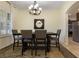 Dining room with modern chandelier, large window, and a mirror accent at 930 Willow Oak Loop, Minneola, FL 34715