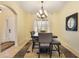 Dining area featuring modern chandelier, large window, and a mirror accent on the wall at 930 Willow Oak Loop, Minneola, FL 34715