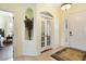 Bright foyer with tile flooring, an arched doorway, and a decorative niche with peacock feathers at 930 Willow Oak Loop, Minneola, FL 34715