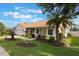 Well-maintained home with a lush lawn, mature landscaping, and inviting covered front porch at 930 Willow Oak Loop, Minneola, FL 34715