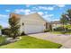 Home with a two-car garage, brick paved driveway, and well-maintained front yard at 930 Willow Oak Loop, Minneola, FL 34715