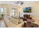 Bright living room with ceiling fan, modern furniture, and stylish decor at 930 Willow Oak Loop, Minneola, FL 34715