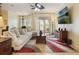 Open living room featuring a comfortable sofa, large windows, and stylish decor at 930 Willow Oak Loop, Minneola, FL 34715