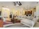 Open-concept living area with views into dining and kitchen, features a large sofa at 930 Willow Oak Loop, Minneola, FL 34715