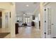 Open-concept living room with tile floors, neutral walls, and French doors leading to the backyard at 930 Willow Oak Loop, Minneola, FL 34715