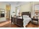 Main bedroom features a dark wood bed set, wood floors and plenty of natural light at 930 Willow Oak Loop, Minneola, FL 34715