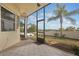 Enjoy a private screened patio with tiled floors and views of the landscaped backyard at 930 Willow Oak Loop, Minneola, FL 34715