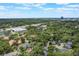 An aerial view of the neighborhood showcasing the community pool, lush greenery, and nearby amenities under a bright sky at 940 Douglas Ave # 159, Altamonte Springs, FL 32714