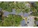 Birds eye view featuring the neighborhood, showcasing the gray roof tops and parking spaces, with surrounding lush trees at 940 Douglas Ave # 159, Altamonte Springs, FL 32714