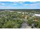 Scenic aerial view of residential neighborhood, surrounded by lush greenery, under a bright blue sky with scattered clouds at 940 Douglas Ave # 159, Altamonte Springs, FL 32714